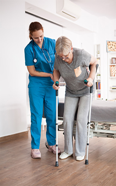 old woman in nursing home walking with crutches